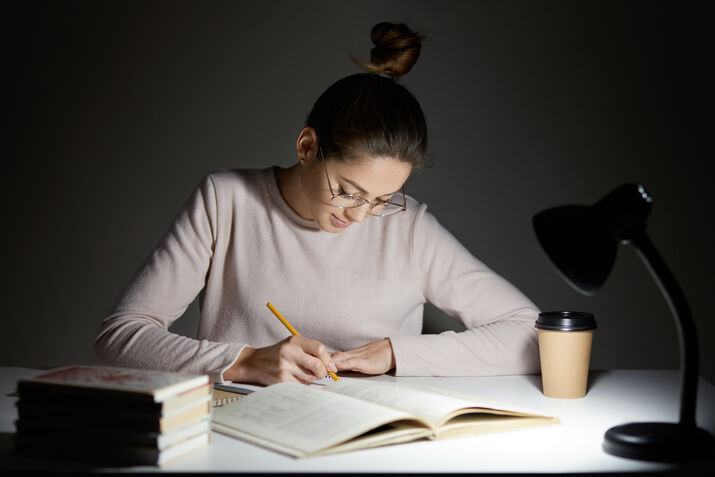 woman writing book manuscript