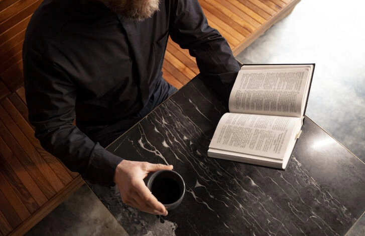 author reading book with coffee