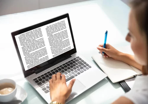 businesswoman-reading-information-laptop